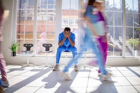 A person sitting in a room with his hands covering his face

AI-generated content may be incorrect.